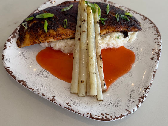 Chef presenting a finished culinary creation